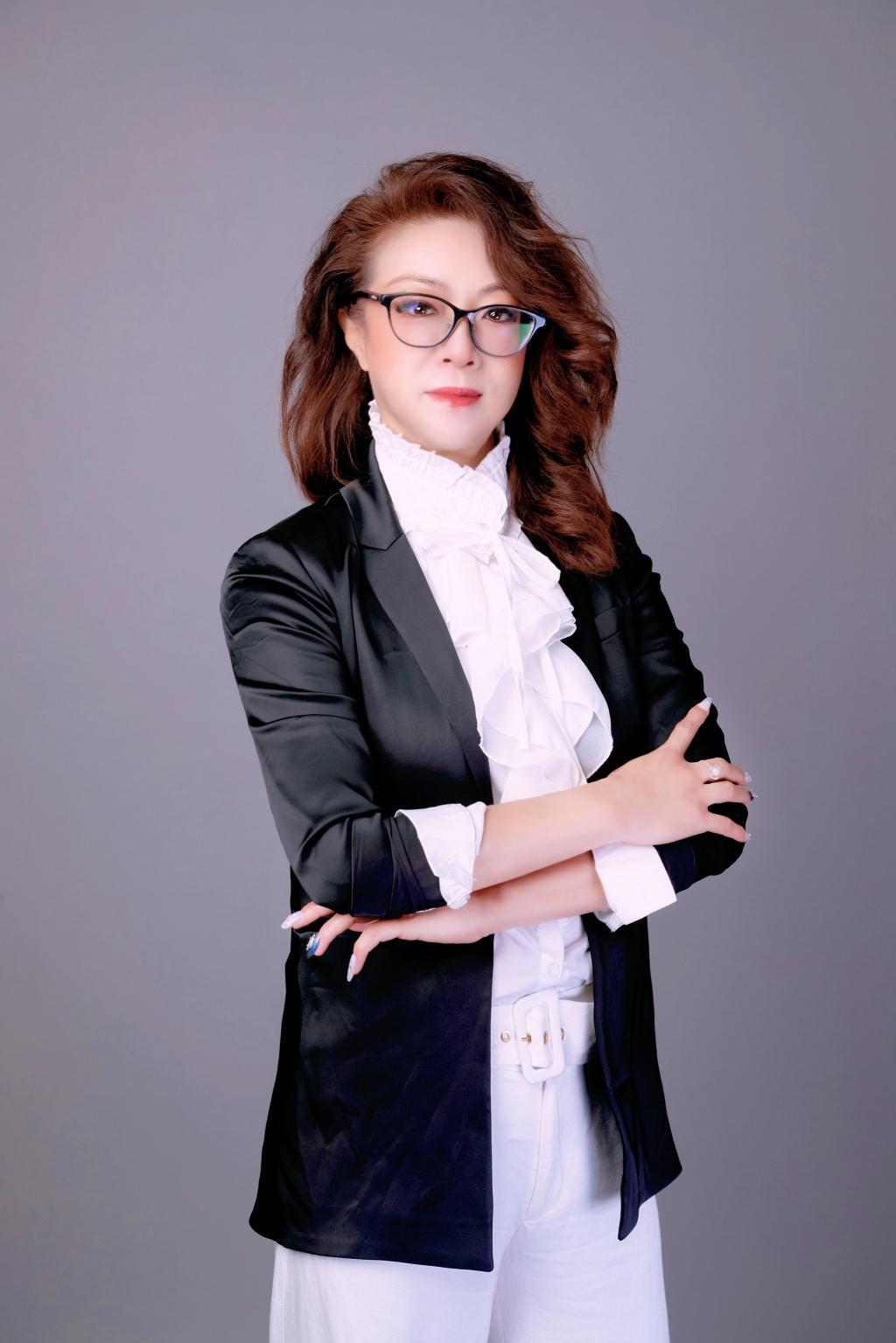 Natasha Wang seated in a warm advisory office reviewing planning documents
